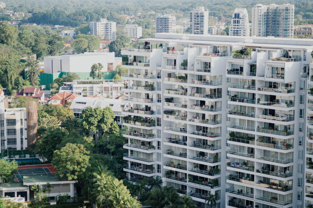 Aerial view of modern high-rise residential buildings surrounded by greenery in Singapore